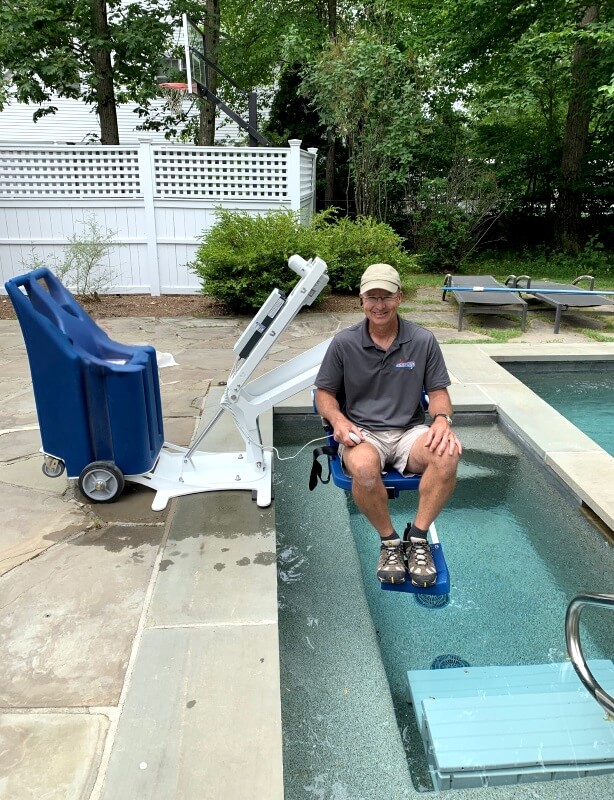 The Amramp CT & Eastern NY team installed this pool lift for a client in Westport, CT so he now has access to his hot tub and pool. Here Bob Danek is testing out the unit before letting the customer go on it!
