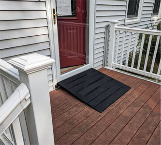 Threshold wheelchair ramp outside of house on deck