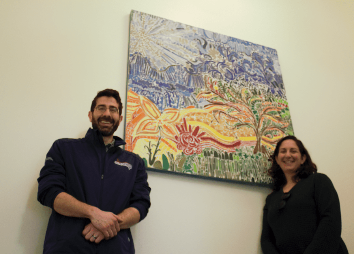 Justin Gordon and artist, Audrey Markoff, stand in front of her piece, Frankie Valli, which now stands in the entry way of Amramp’s new facility in Randolph.