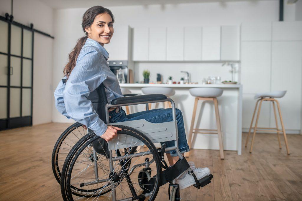 A smiling young woman sitting in a wheelchair