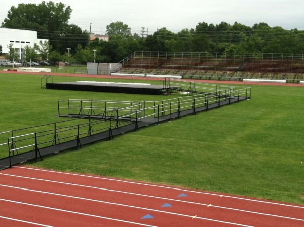 a stage in a football field with a ramp in Fairlawn New Jersey for Graduation