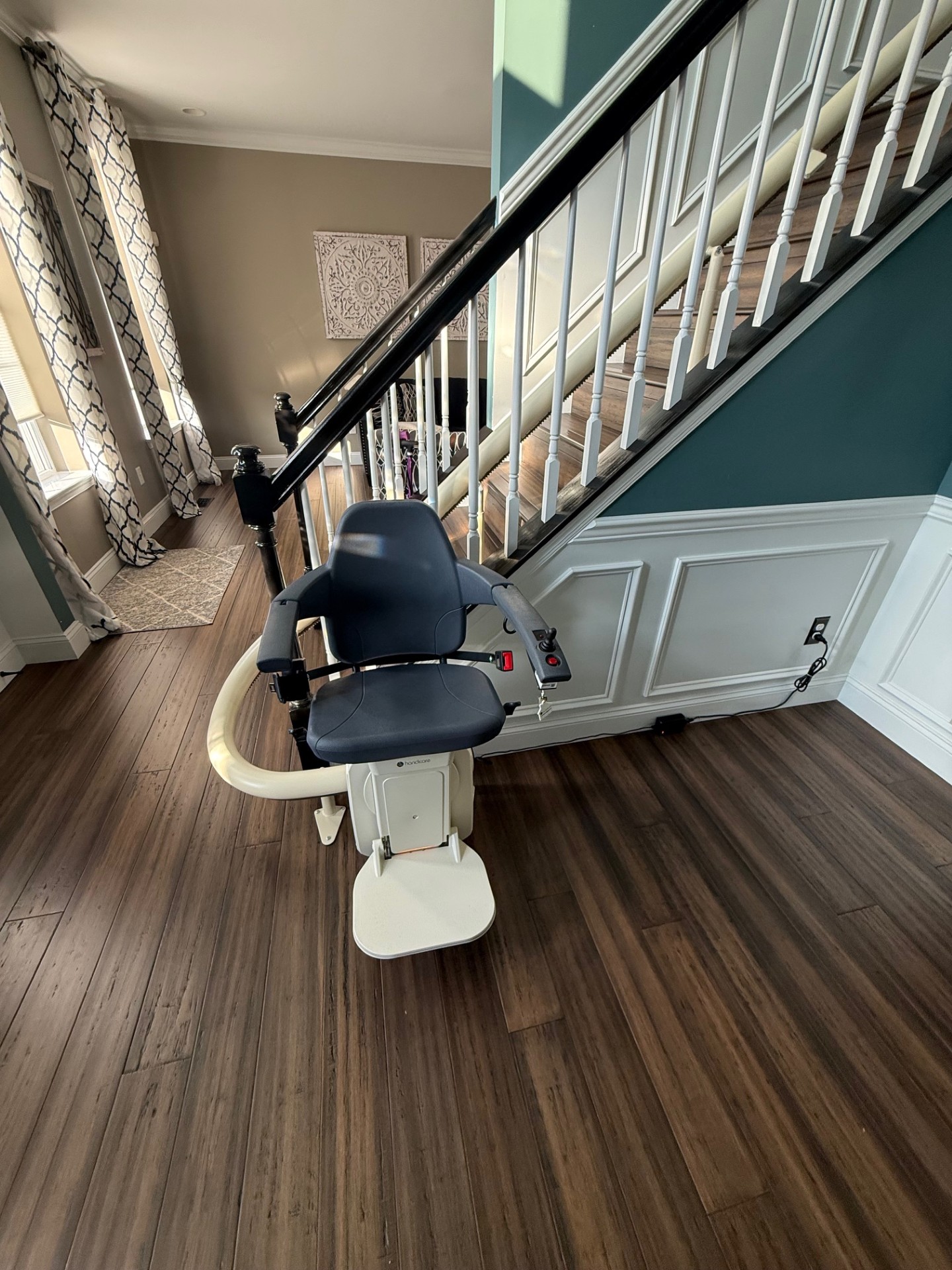 A curved stairlift with an overrun at the top and 180 degree turn at the bottom installed by Amramp Accessibility of Philadelphia.