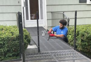 an installer at Amramp makes sure the ramp is level and sturdy