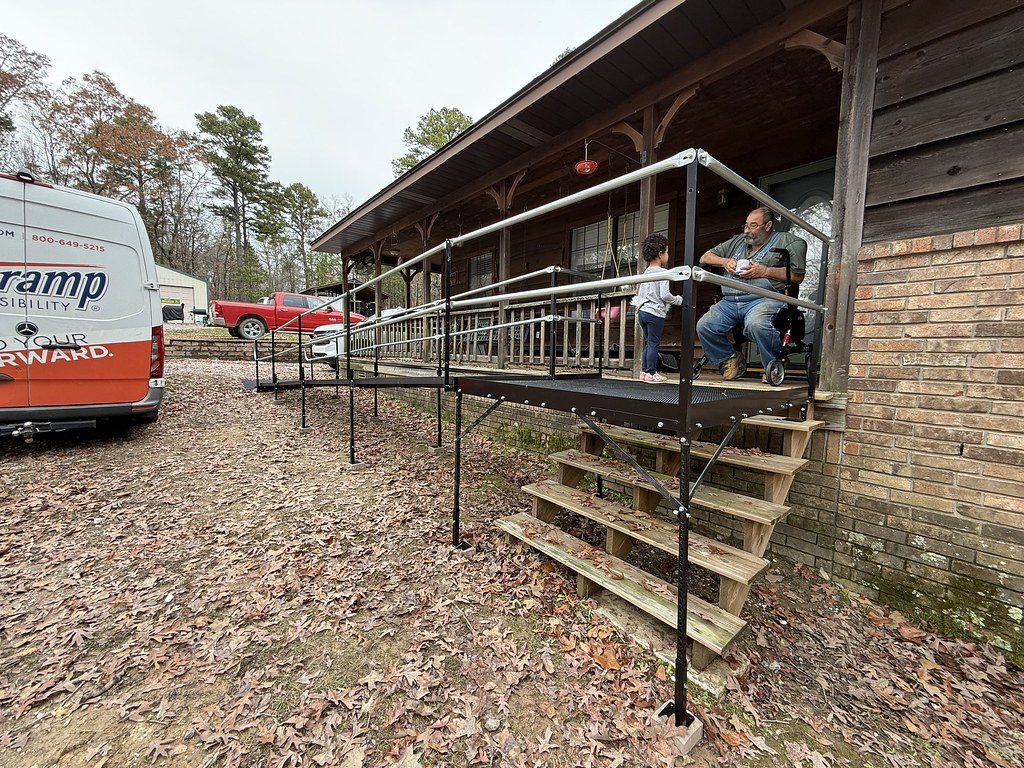 a person using a powered wheelchair to move down a ramp