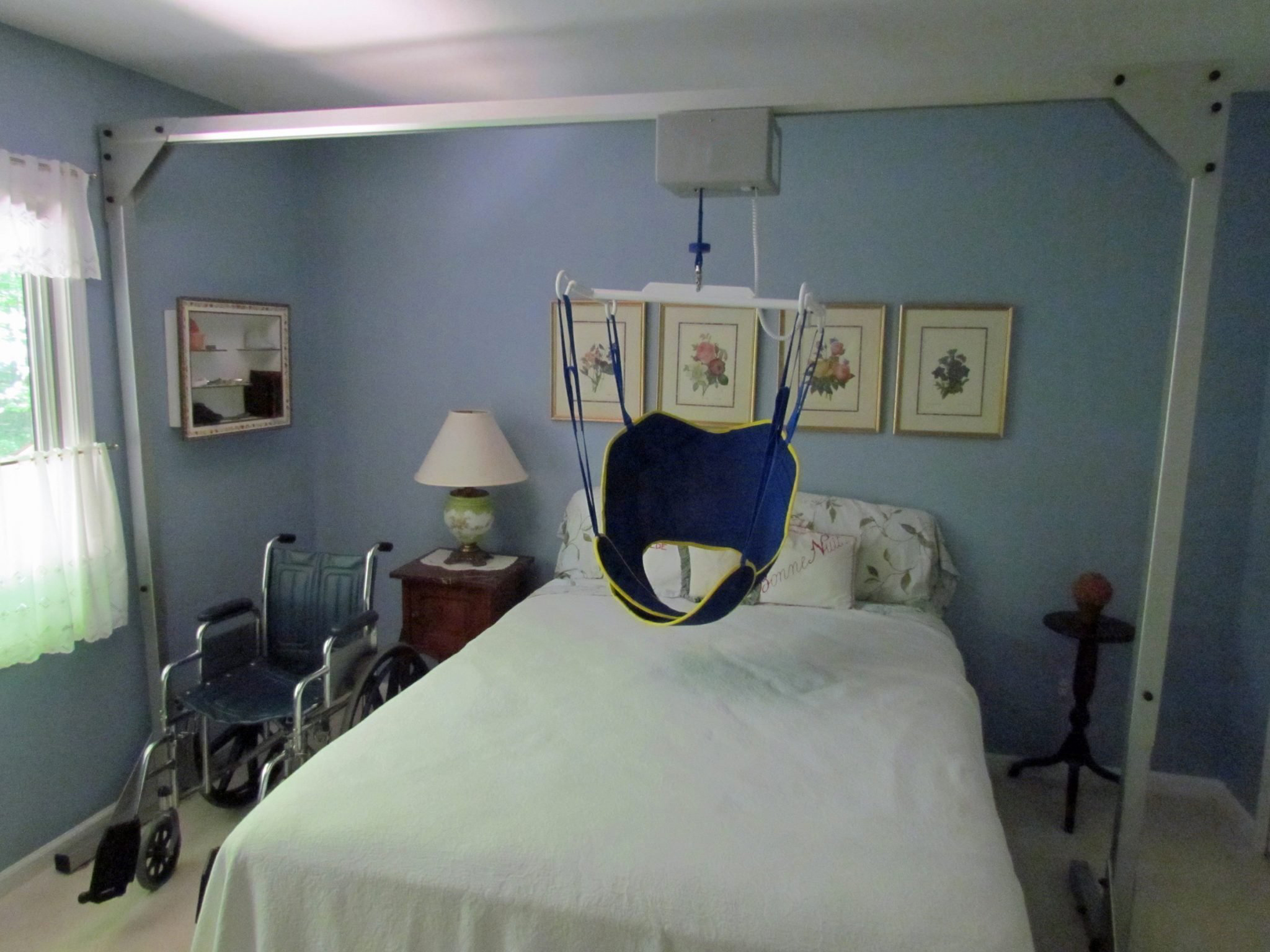 An overhead patient lift in a room designed to support both caregiver and patient