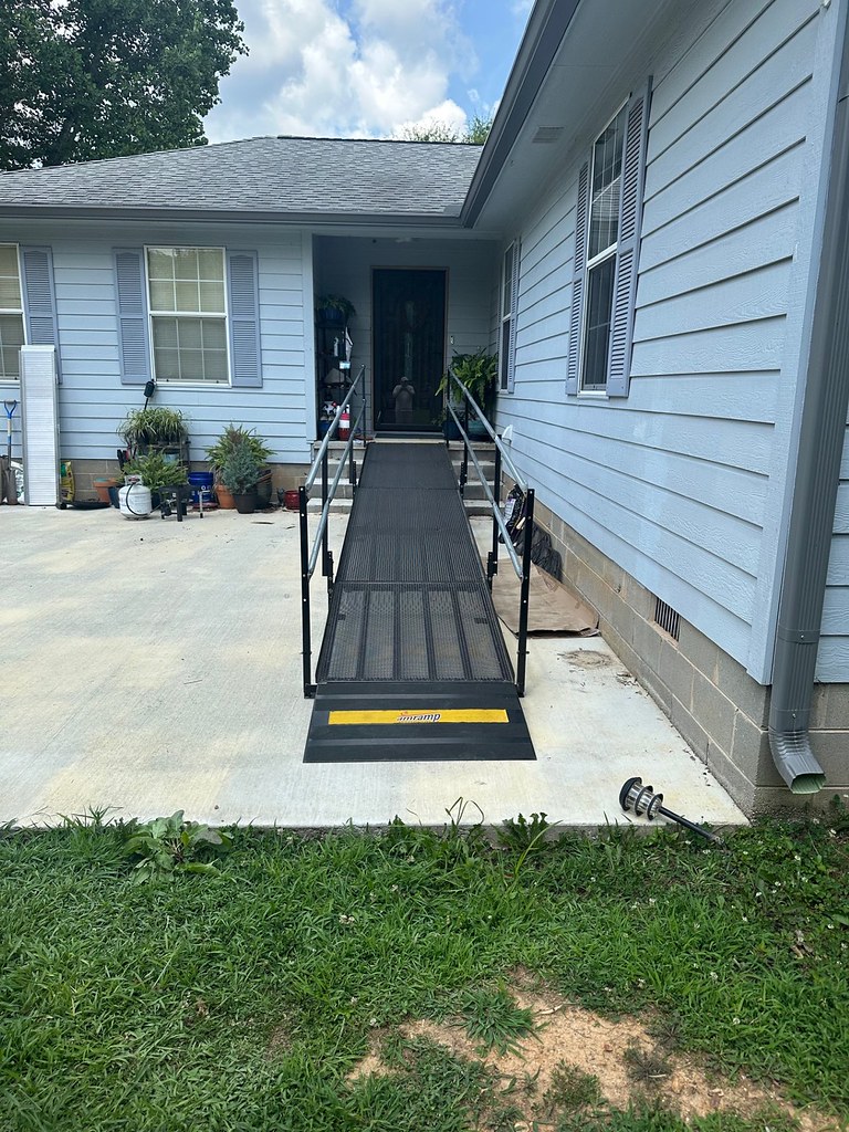 Modular wheelchair ramp installed at the front entrance of a residential home to provide safe and accessible access.