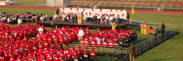 An aerial photo of an accessible graduation ceremony with an Amramp wheelchair ramp leading up to the stage