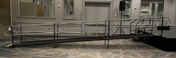 An Amramp steel modular wheelchair ramp providing access to a stage for a corporate event