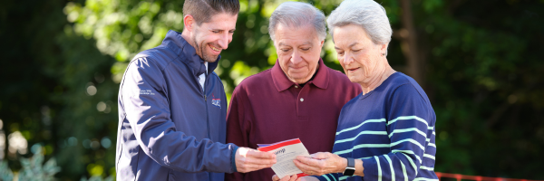 A couple reviewing a brochure of Amramp products with an Amramp representative