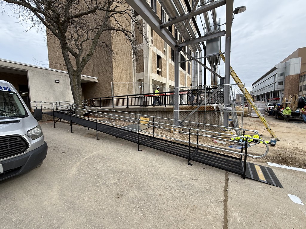 Amramp commercial wheelchair ramp installed outside a large commercial building to provide an accessible entrance.