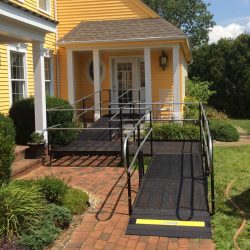 Modular wheelchair ramp installed at the front entrance of a residential home.