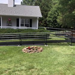 Custom wheelchair ramp wrapping around the front yard of a residential home.