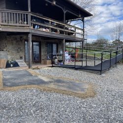 Modular wheelchair ramp providing access beneath an elevated residential home.