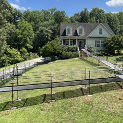 Long modular wheelchair ramp installed on a sloped residential property.