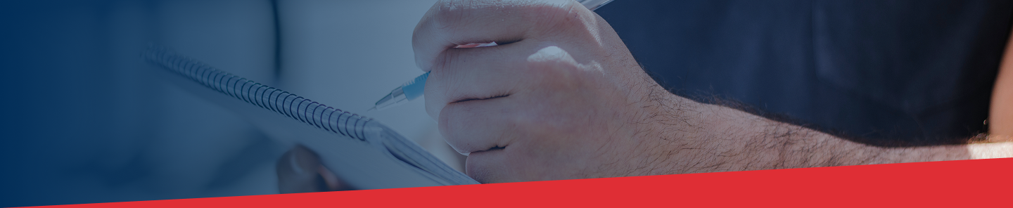 a view of a hand holding a pen next to a checklist