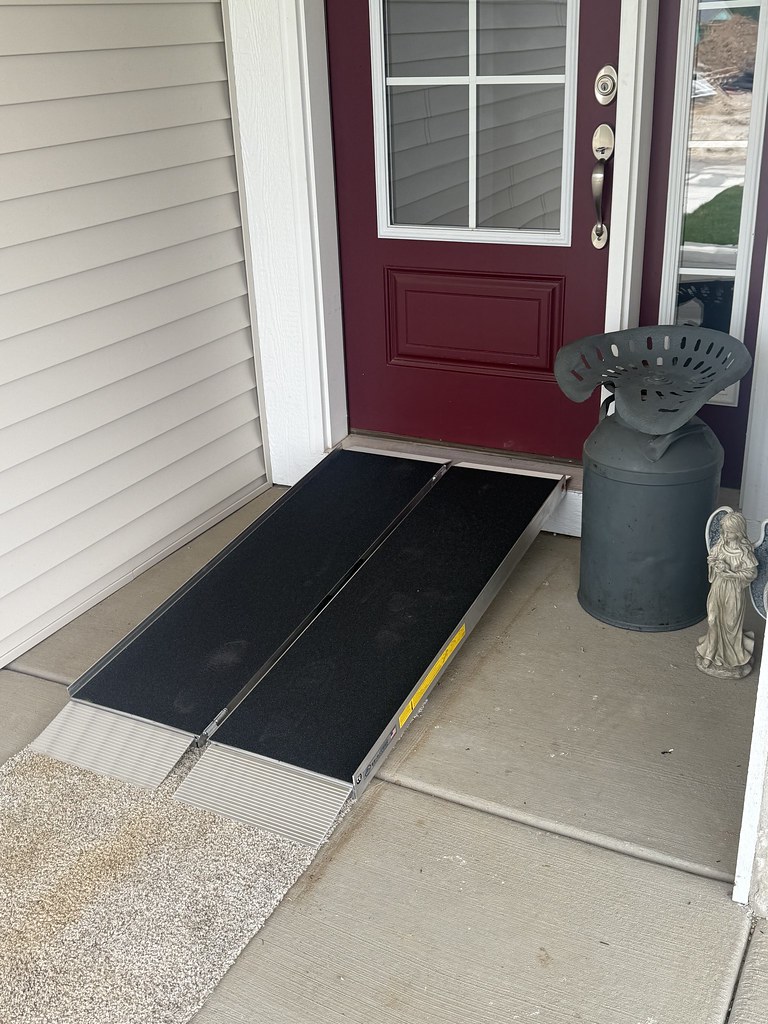 Portable threshold wheelchair ramp installed at the front entrance of a home to provide safer, step-free access.