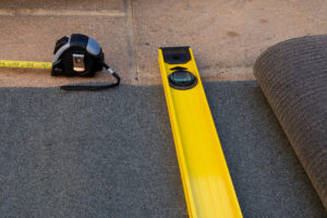 Measuring tape and level tool on a surface, used for precise measurements and ensuring accurate alignment during installation.