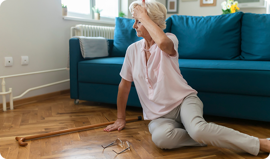 a woman who appears to have fallen down in front of a green couch